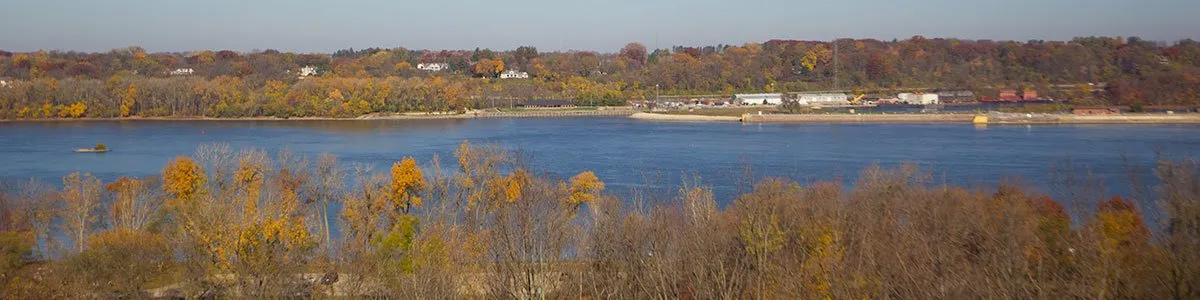 A blurry picture of a lake with trees in the background.
